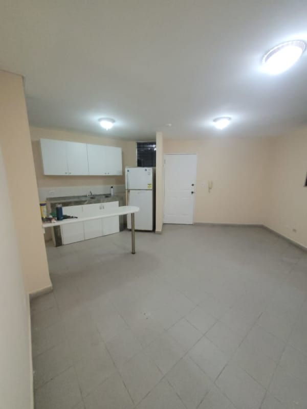 Kitchen featuring tile floors, double sink, refrigerator space, and breakfast bar at PH Morada del Sol 12 de Octubre