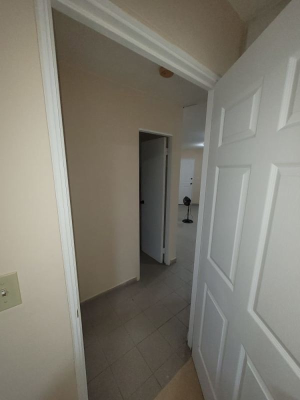Simple corridor with beige walls and tiled floors connecting rooms in PH Morada del Sol Panama