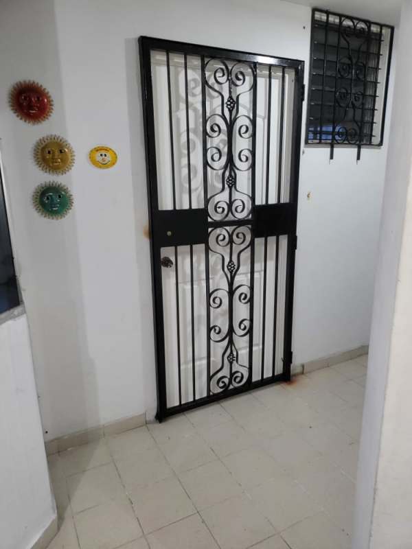 Secure front door with wrought iron gate and decorative wall art in PH Morada del Sol Panama City