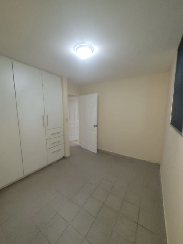 Bedroom with built-in closet and tile floors in PH Morada del Sol, Panama City for sale