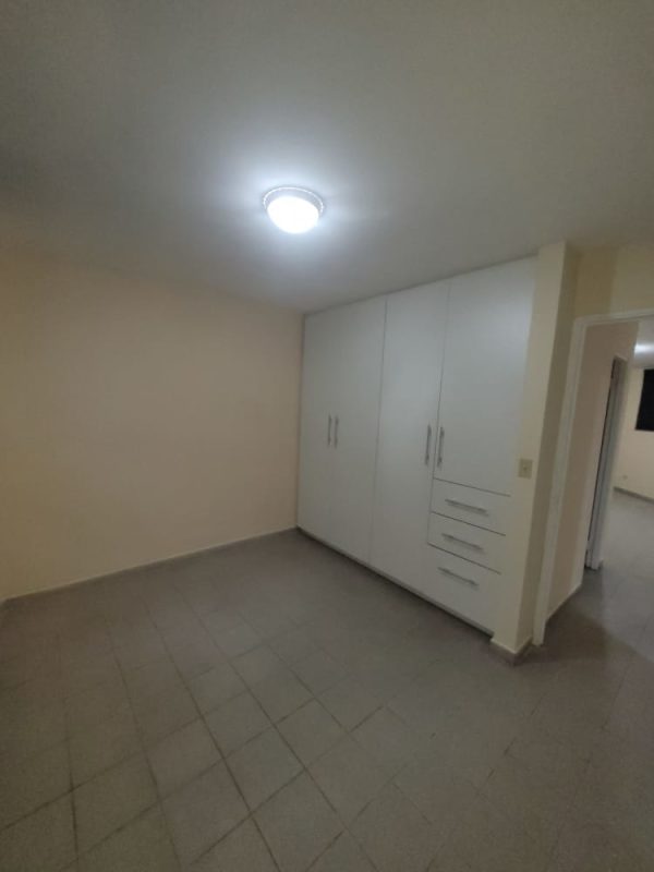 Bedroom featuring built-in closet, tile floors, and neutral decor in PH Morada del Sol 12 de Octubre Panama