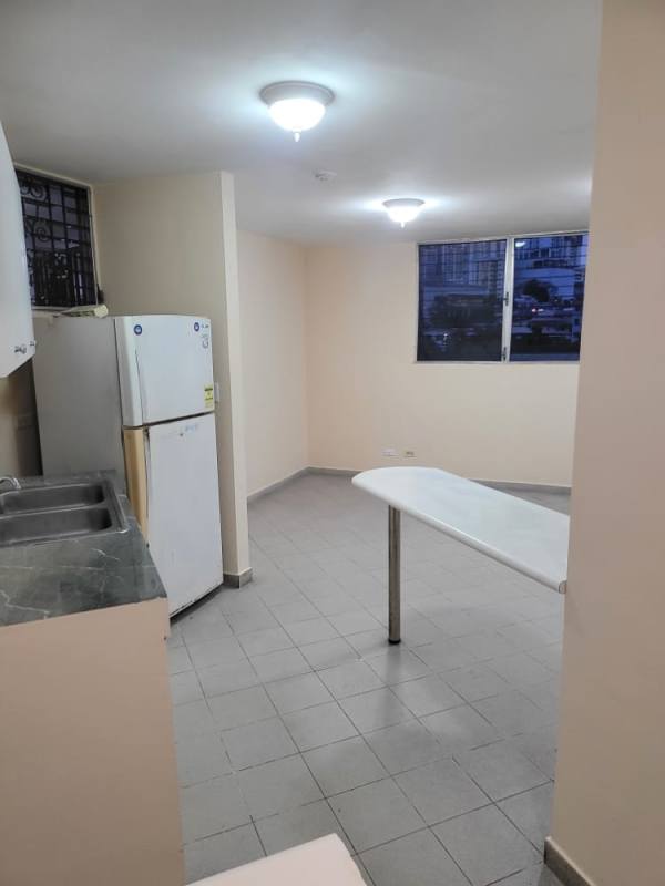 Minimalist apartment kitchen with white cabinets and tile floors PH Morada del Sol 12 de Octubre Panama