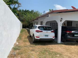 House with attached carport, white fence, parking and garden in Nueva Gorgona Panama