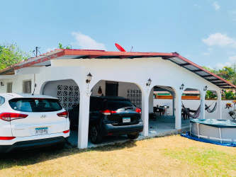 Single-story house with red roof, carport, patio, pool Nueva Gorgona Panama