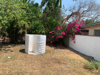 Single-story home with porch, hammock, and tropical garden Nueva Gorgona Panama