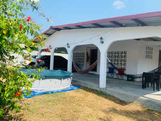 Covered outdoor patio with hammocks and above-ground pool in Nueva Gorgona Panama