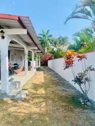 Garden with flowers, water tank and surrounding greenery in Nueva Gorgona Panama