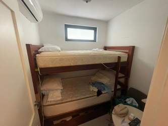 Compact bathroom with tiled shower, vessel sink, and window Punta Caelo beach condo Panama