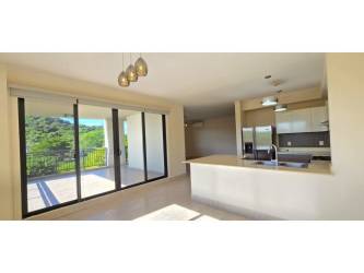 Modern open kitchen with breakfast counter at River Valley Panama Pacifico