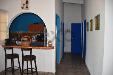 Traditional kitchen with archway window, blue walls, and appliances Playa Malibu Panama