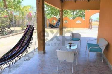 Bedroom featuring twin beds, AC unit, and closet Playa Malibu beach property for sale