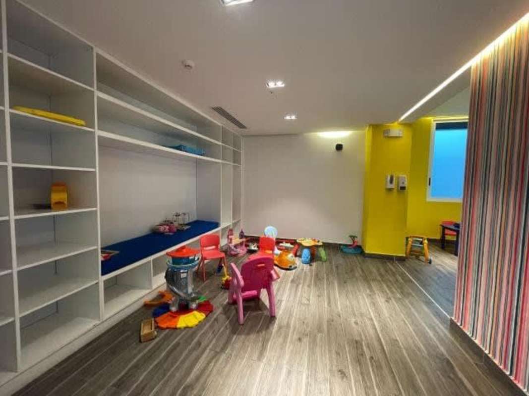 Modern bright indoor children's play area with colorful toys at The Towers Panama