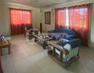 Spacious living room tiled floor with blue sofa and AC Altos del Fraile Chitré