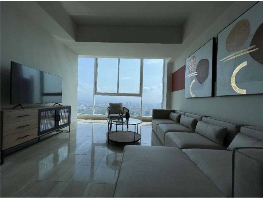 Luxury master bedroom with large windows, city and sea view, modern furnishings at PH The Regent Costa del Este Panama.