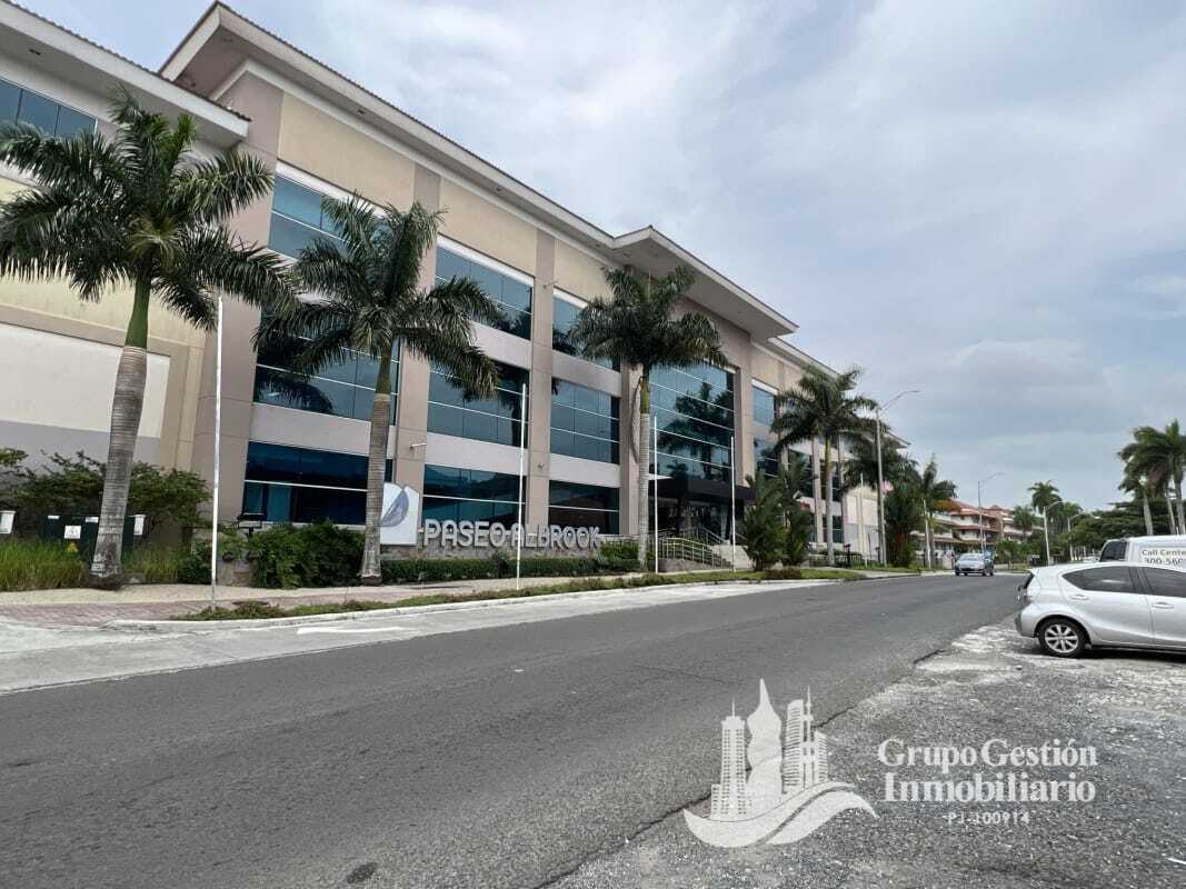 Modern commercial complex with glass facade and palm trees Paseo Albrook Panama
