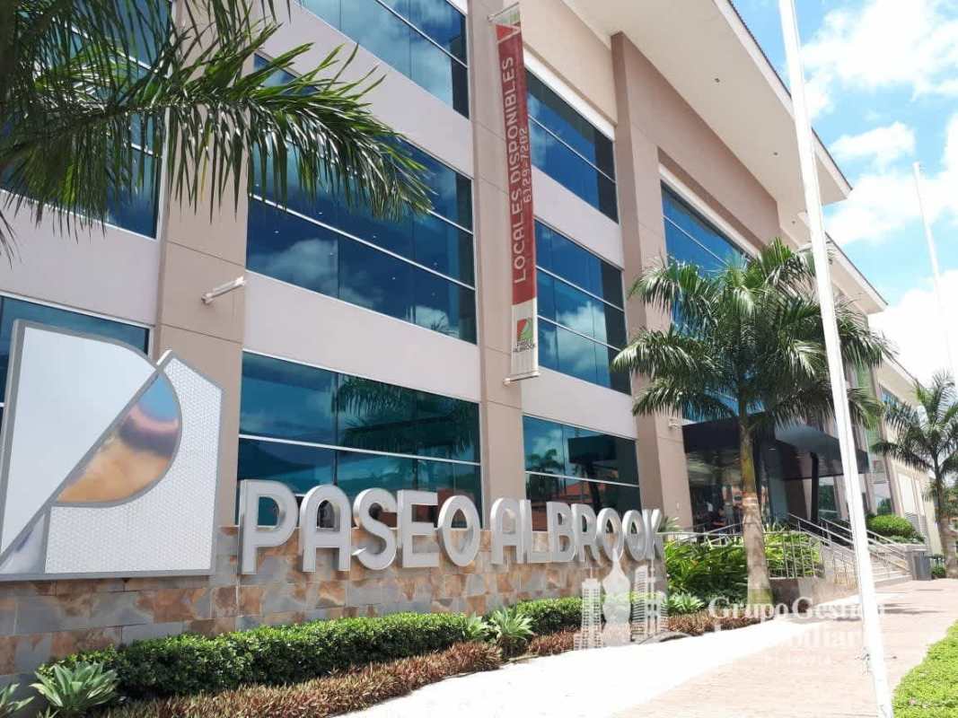 Modern multi-story mall facade with signage and palms Paseo Albrook for lease in Panama