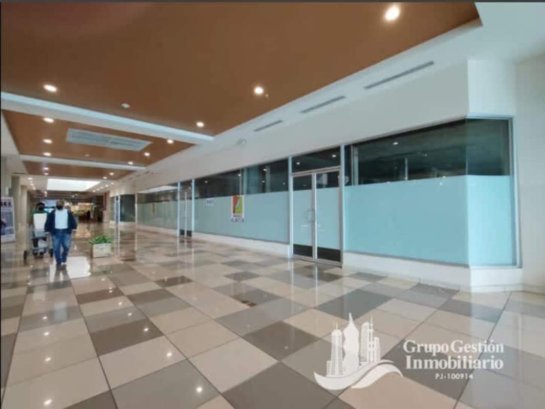 Modern commercial corridor with glass storefronts at Paseo Albrook mall Panama