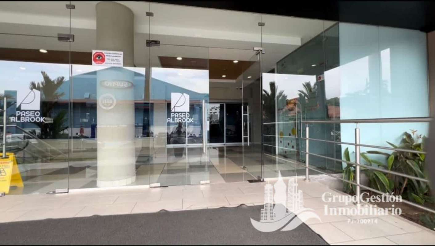 Glass doors entrance with signage at Paseo Albrook Panama shopping center