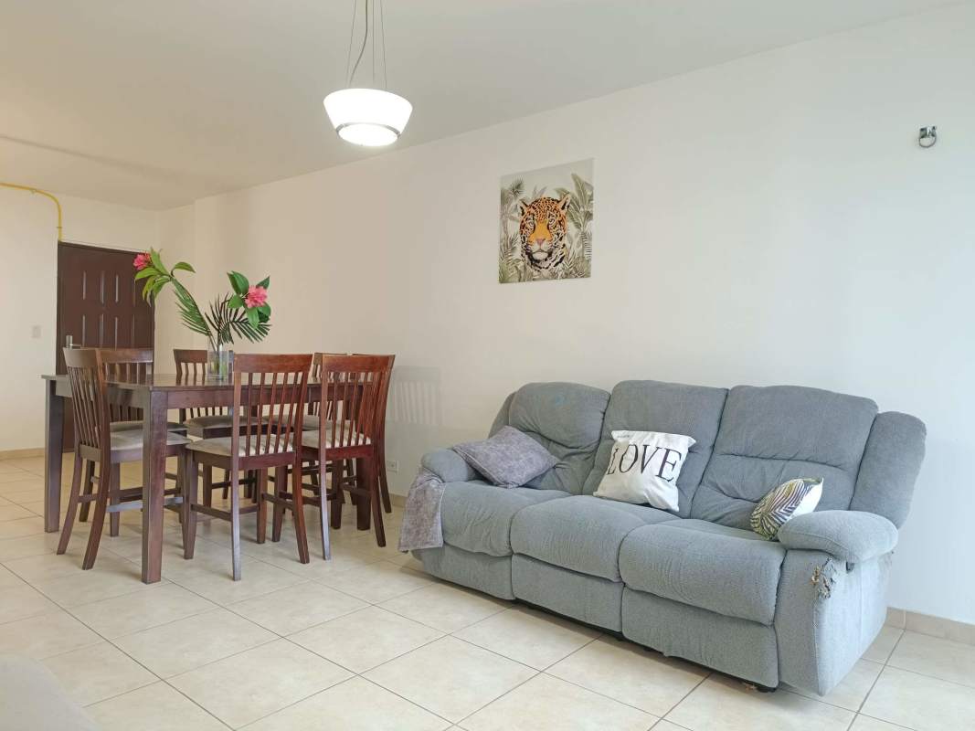 Open plan living and dining area with balcony access at PH San Francisco Bay apartment Panama