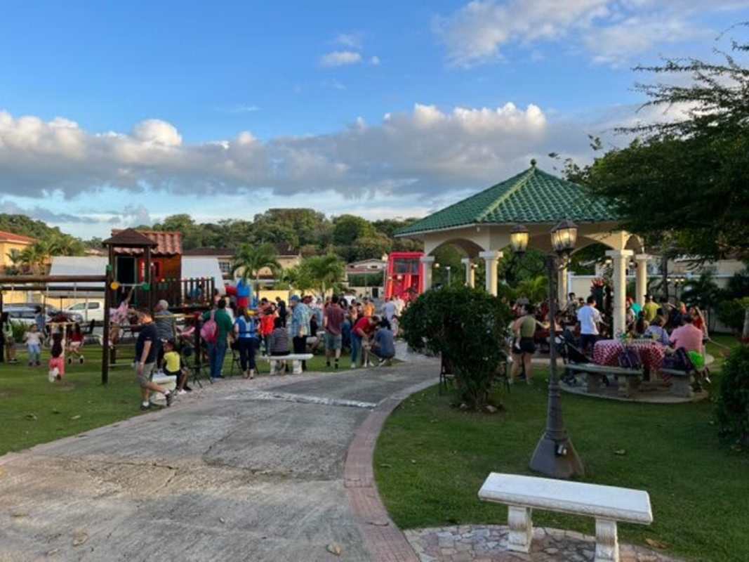 Modern commercial complex with glass storefronts parking and signage in Albrook, Panama