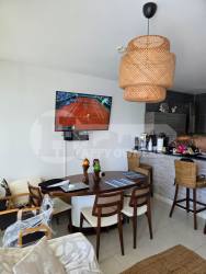 Contemporary open-plan kitchen with granite counters and dining area in Rio Mar Villages beachfront apartment Panama
