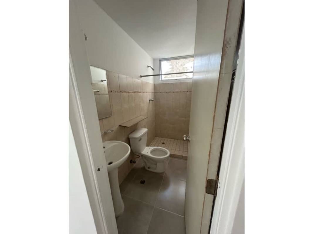 Minimalist bathroom beige tiles pedestal sink toilet bidet window PH Mystic Park Juan Díaz Panama