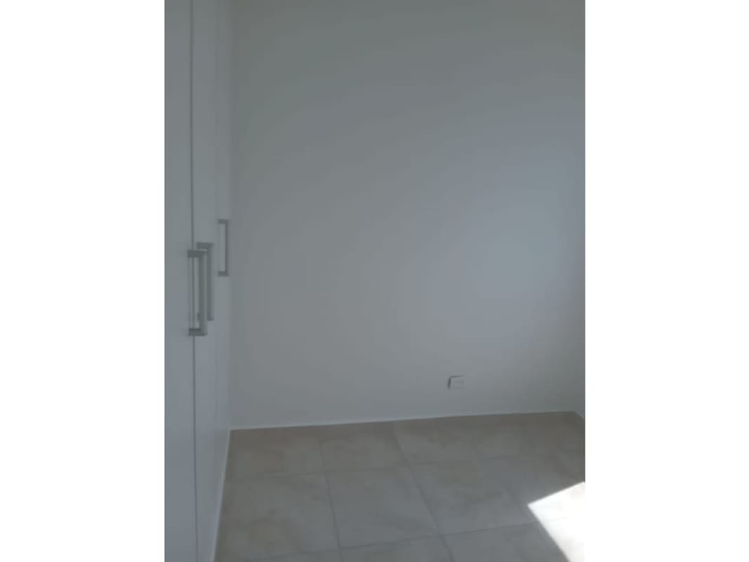 Empty bedroom with tile flooring large window in PH Mystic Blue Panama City