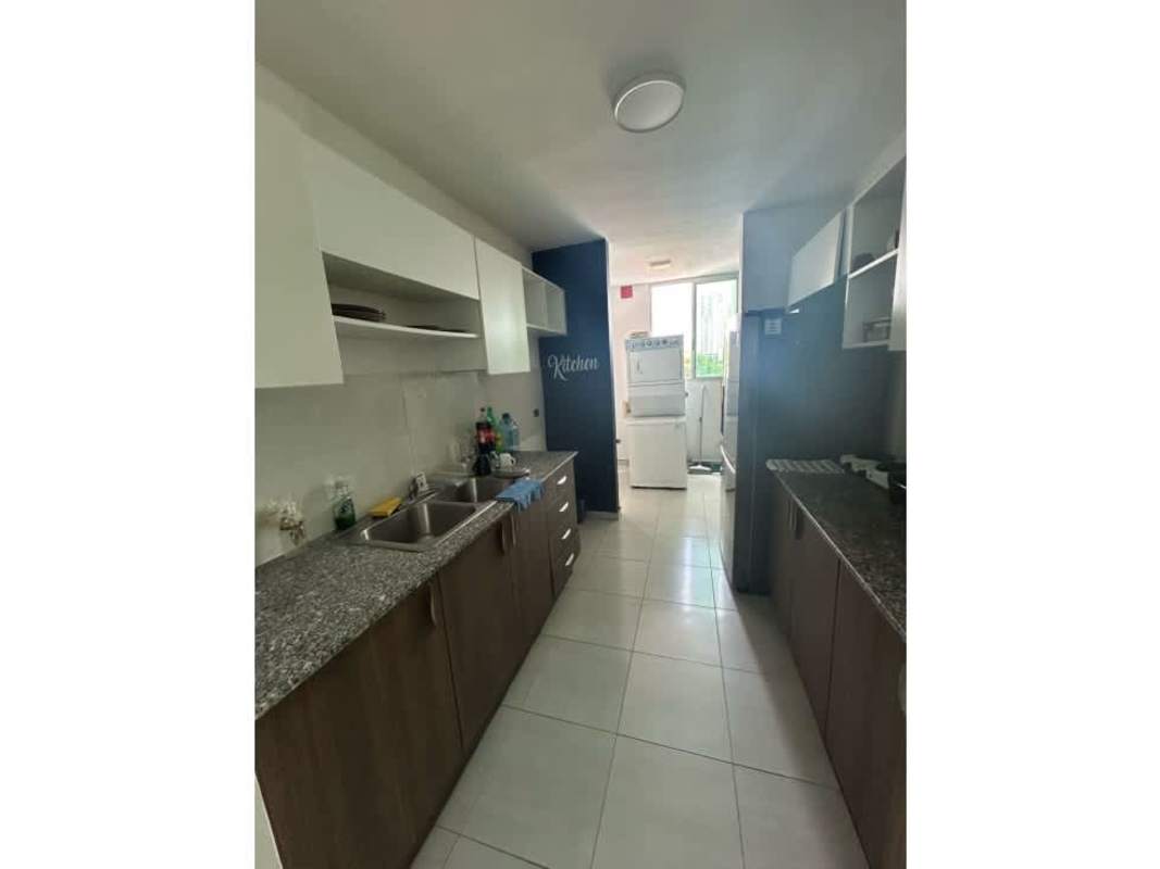 Kitchen with granite counters, white cabinets, laundry area in PH Altavista Tower Panama City