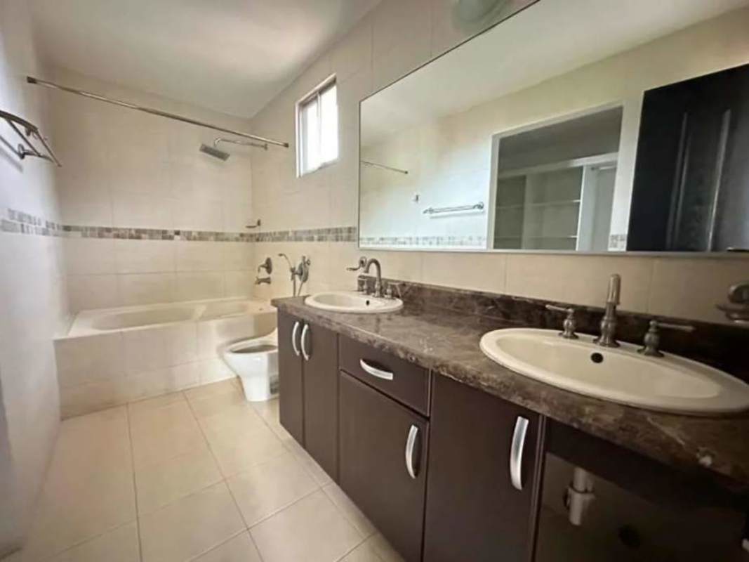 Modern bathroom with glass enclosed shower, vanity and toilet in Paseo Dorado house Ancón Panama City