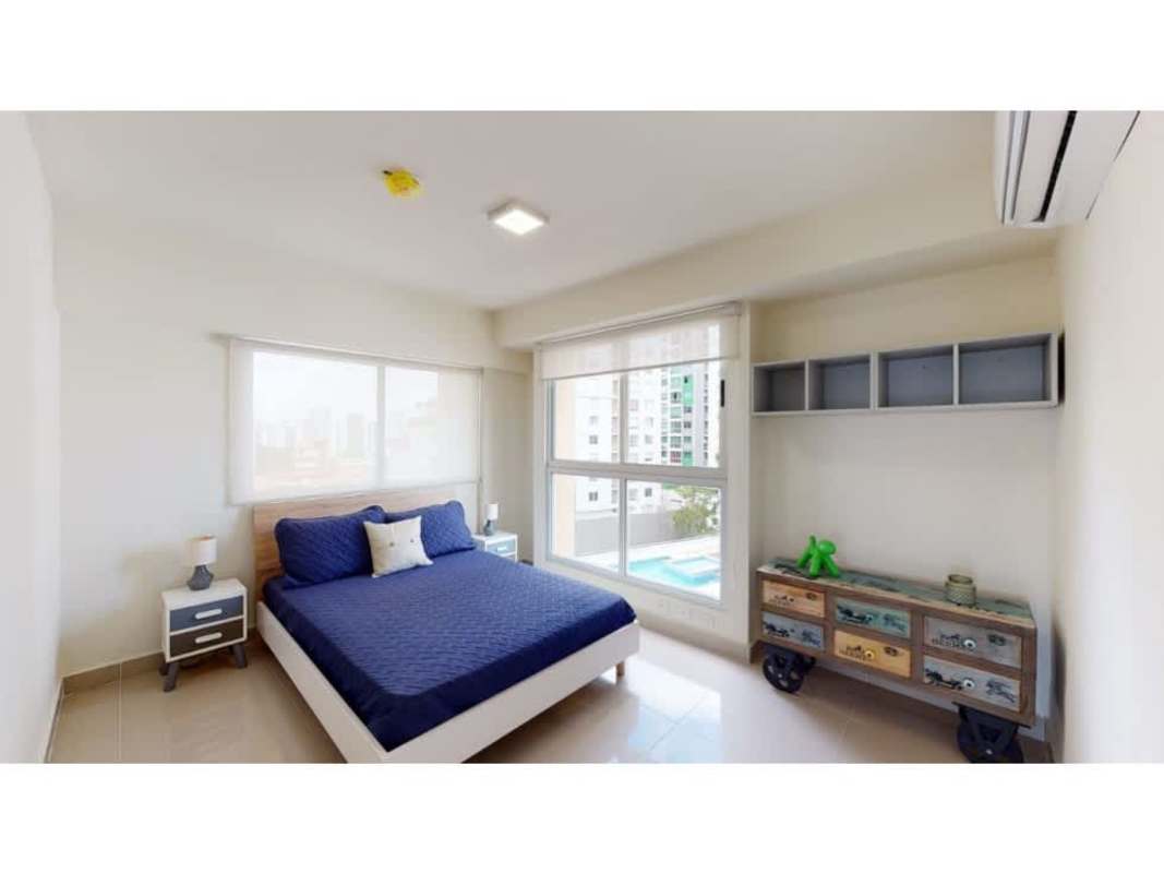 Dining space open to living room with bright windows Panama apartment