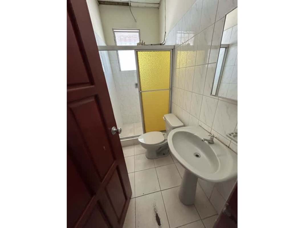 Simple bathroom with tiled walls, pedestal sink, shower enclosure in San Francisco commercial property for rent Panama