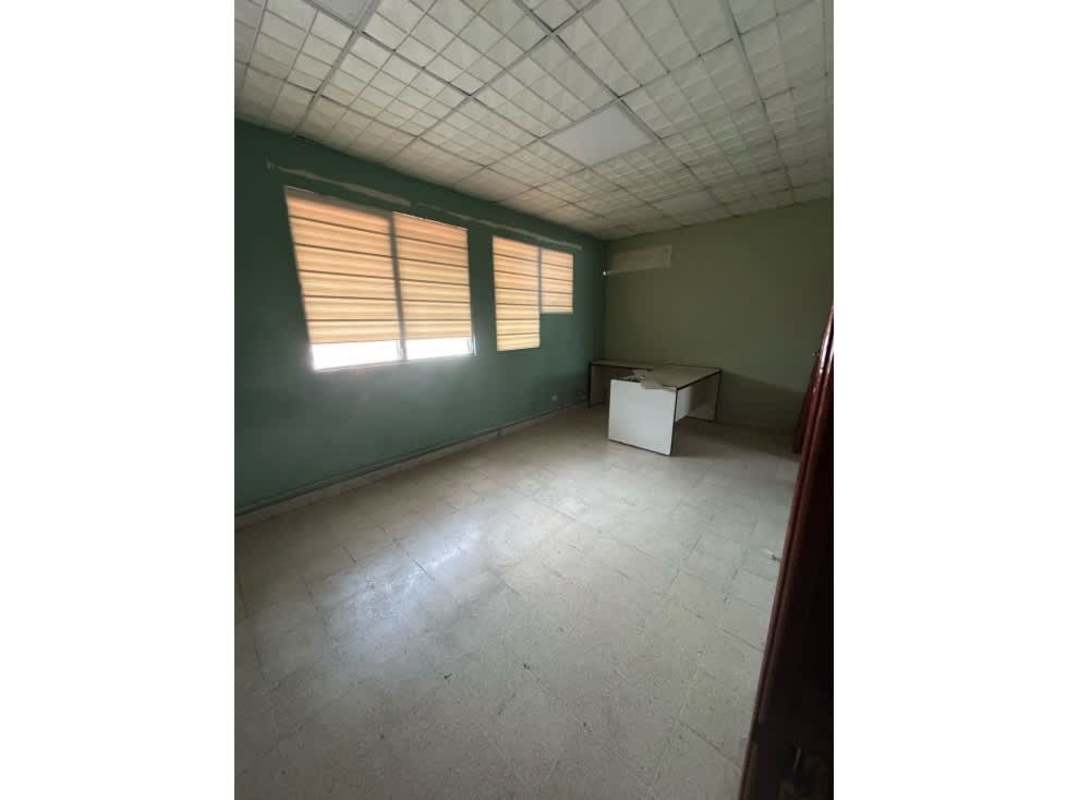 Bright office space with tile flooring, green walls, drop ceiling and window blinds in commercial property San Francisco Panama