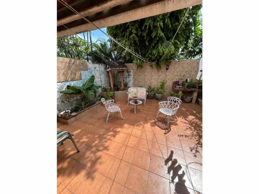Outdoor patio with terracotta tiles and potted plants in Chanis house for sale