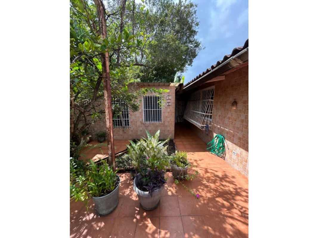 Traditional house facade with carport and white security fence Chanis Panama