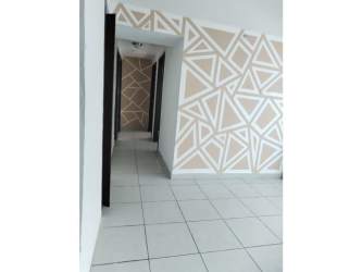 Modern hallway with white tiles leading into apartment at PH Metropolitan Park Panama
