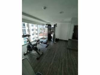 Fully equipped gym with equipment and natural light at Metropolitan Park Panama