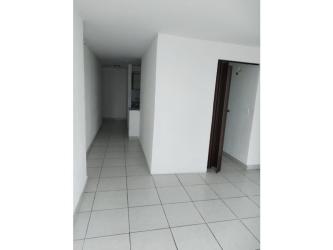 White hallway with ceramic tiles and doorway at PH Metropolitan Park Panama