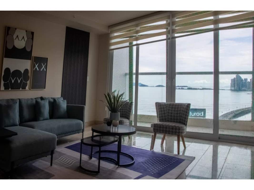 Dining area with modern furniture and ocean view in furnished apartment PH Paramount Panama