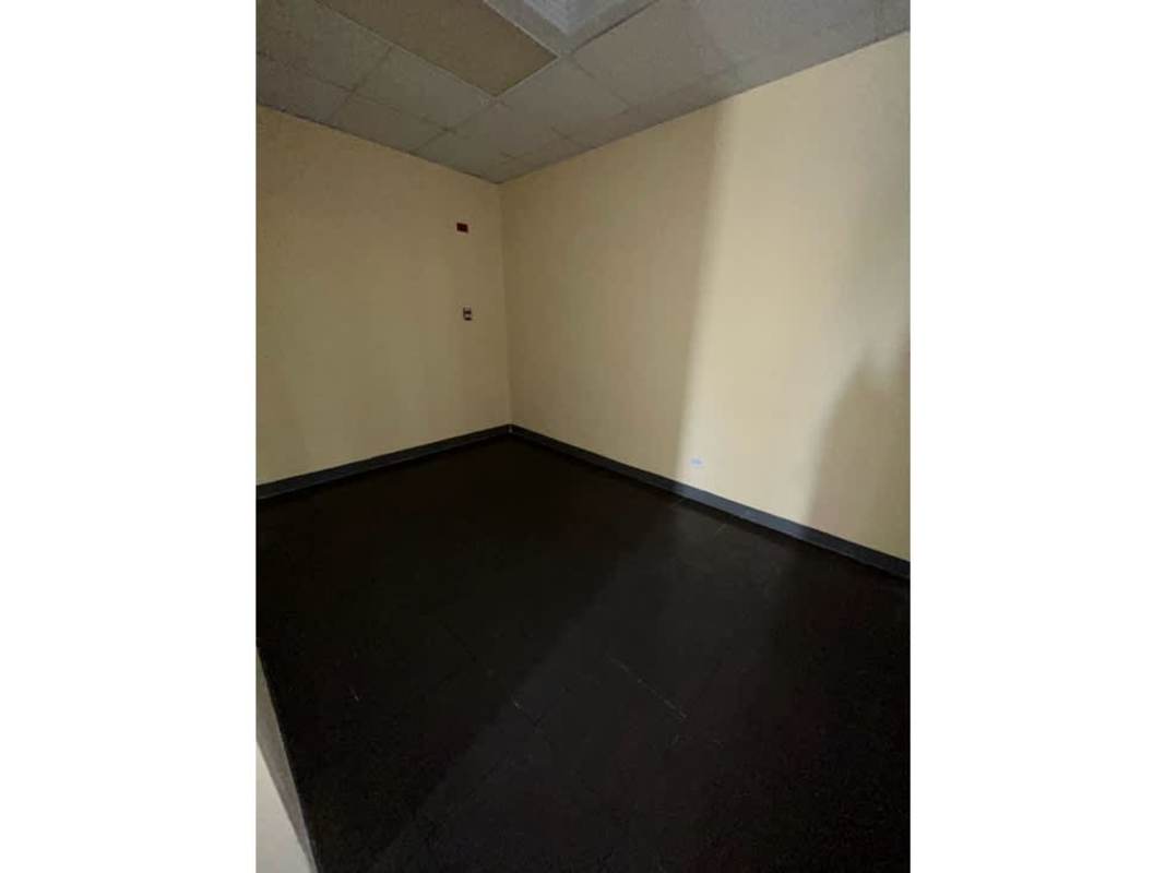 Beige commercial office interior with dark floor and drop ceiling Panama business space