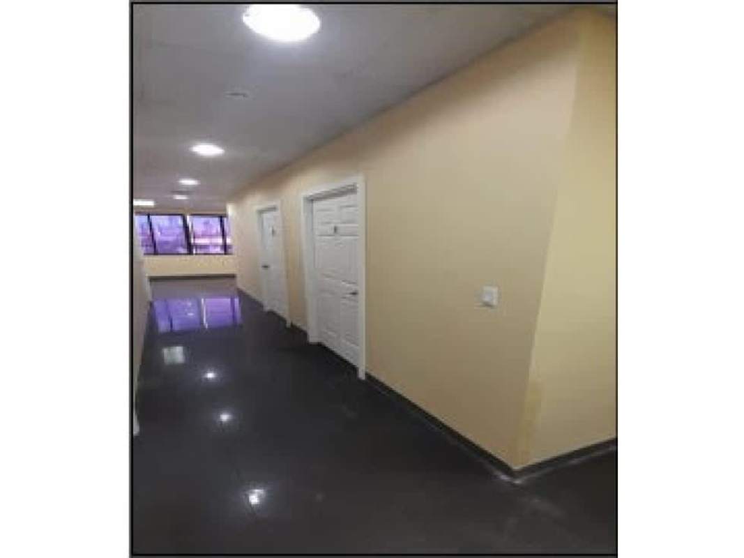 Office corridor with natural light, white doors and glossy tiles in Panama City