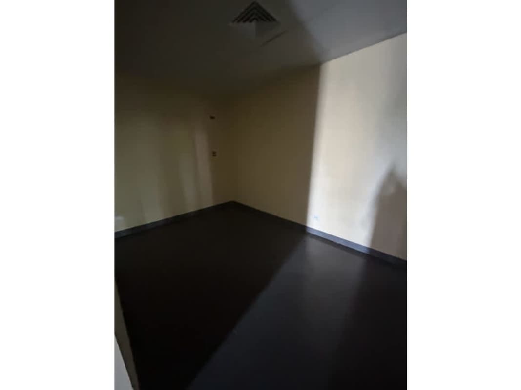 Empty commercial room with beige walls and dark flooring in Panama City