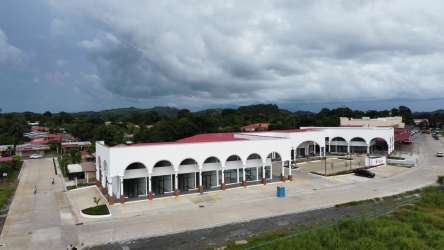 Storefront exterior plaza with arches, large windows, covered walkway at Plaza Firenze Santiago Panama