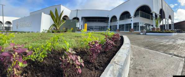 Aerial exterior of Plaza Firenze with arches, red roof, parking Santiago Panama