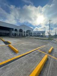 Modern commercial space with large window, concrete driveway at Plaza Firenze Santiago Panama