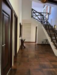 Interior staircase with wood finish leading to upper hallway in mountain house Panama