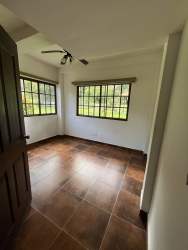 Bedroom with panoramic mountain views via large windows in Altos del María Panama