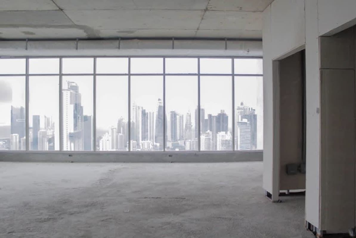 Expansive commercial shell space with large floor-to-ceiling windows overlooking Pacific Ocean in BICSA Tower