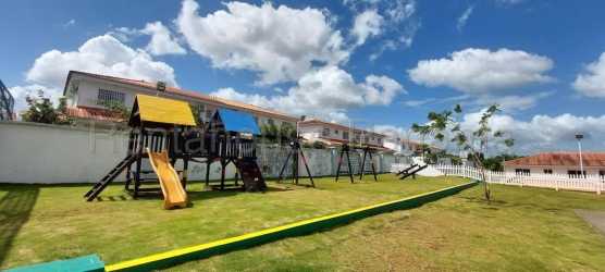 Playground with swings, slides, grassy yard in Versalles Oeste La Chorrera Panama