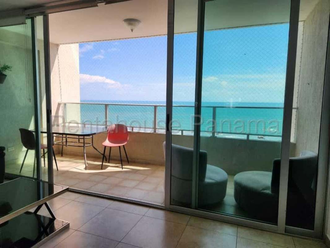 Modern dining area with blue chairs and adjacent kitchen PH Pacific Sea San Francisco Panama