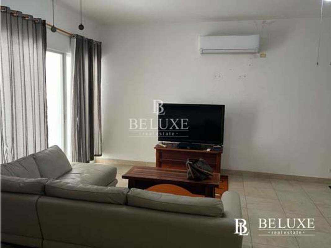 Open plan furnished living and dining space with balcony in PH Amador Hill Panama